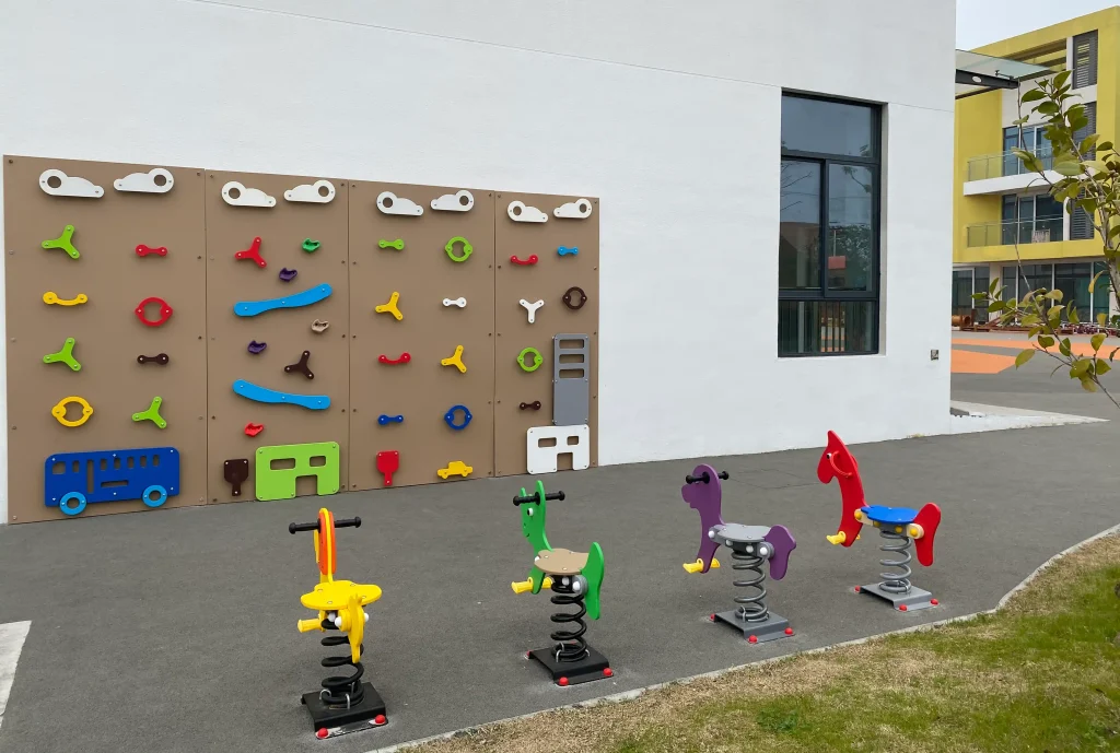 Outdoor play structure with protective surfacing and a clear surrounding circulation route
