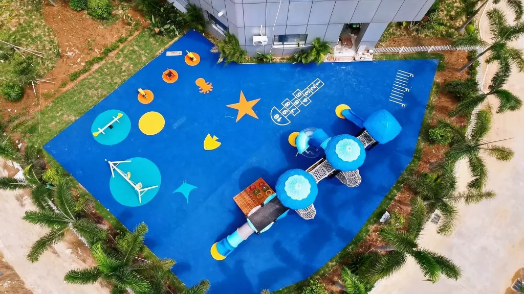 Coastal playground equipment designed for salt-air exposure beside a seafront park